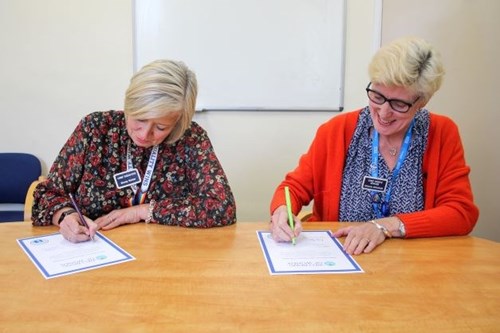 Stacey Hunter (Chief Executive Officer) and Melanie Whitfield (Chief People Officer) signing the Workforce Menopause Pledge for Salisbury NHS Foundation Trust